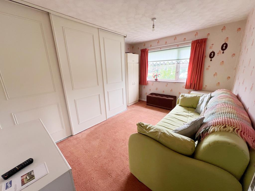 Lot: 116 - END-TERRACE HOUSE WITH DEVELOPMENT POTENTIAL - Bedroom with fitted wardrobes and window to front aspect